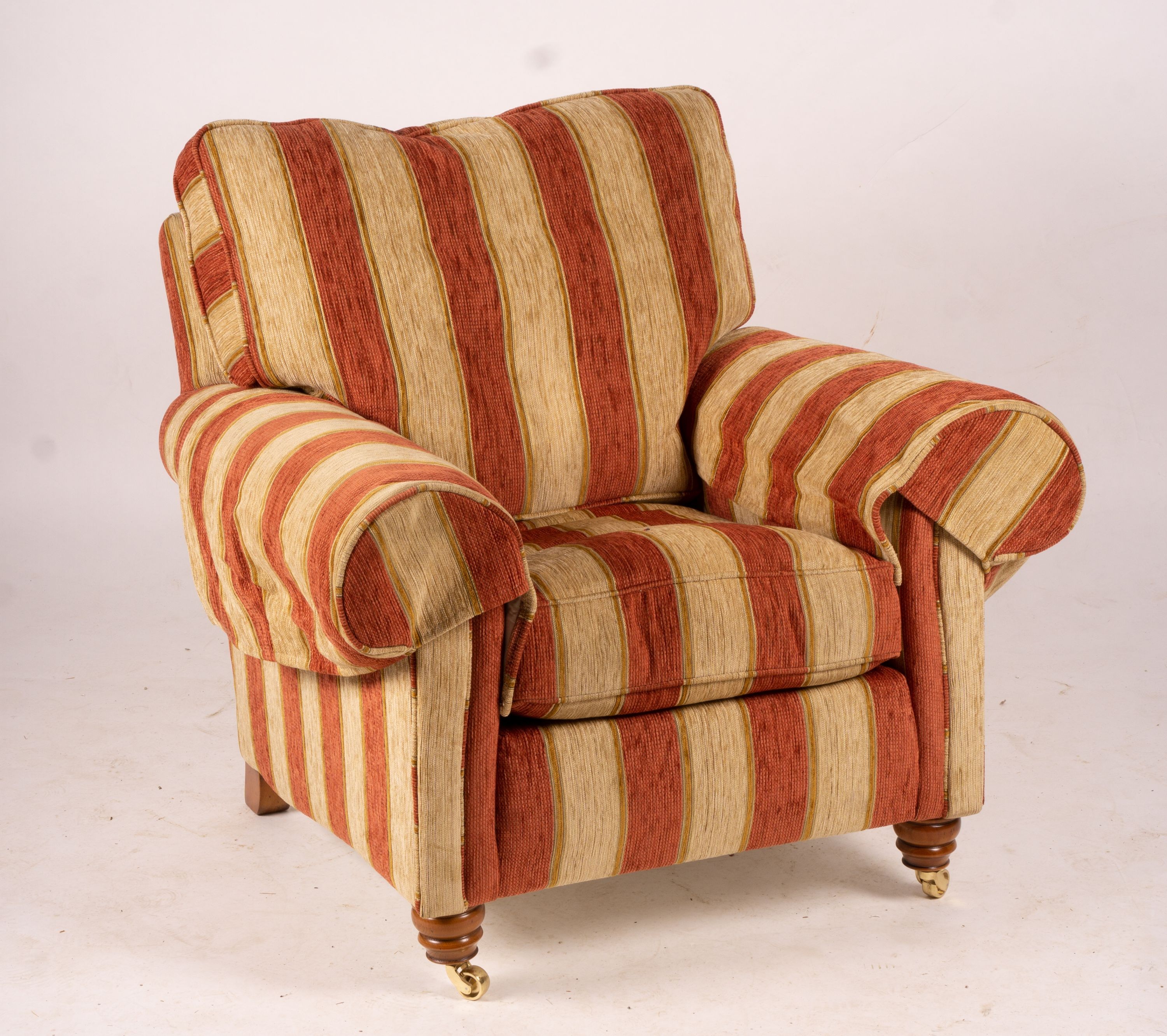 A pair of Duresta armchairs, width 94cm, depth 90cm, height 90cm and matching footstool in striped red and gold fabric